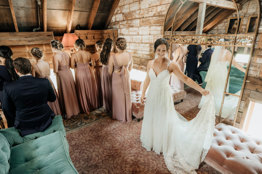 bride ready to show her dress to bridesmaids at valley view farm