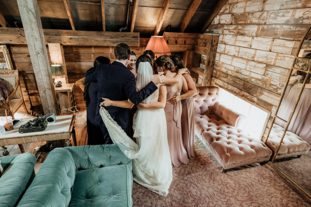 bride hugging bridesmaids at valley view farm